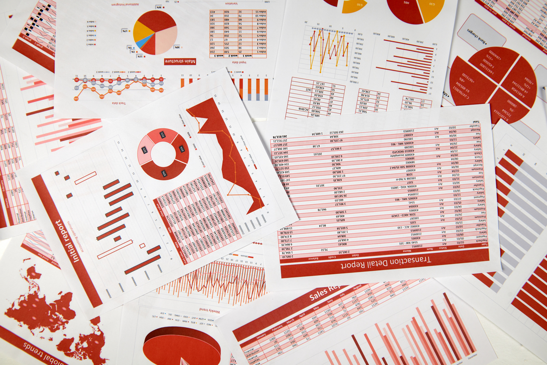 Berichte mit Daten, Tabellen und Analysen liegen auf einem Tisch